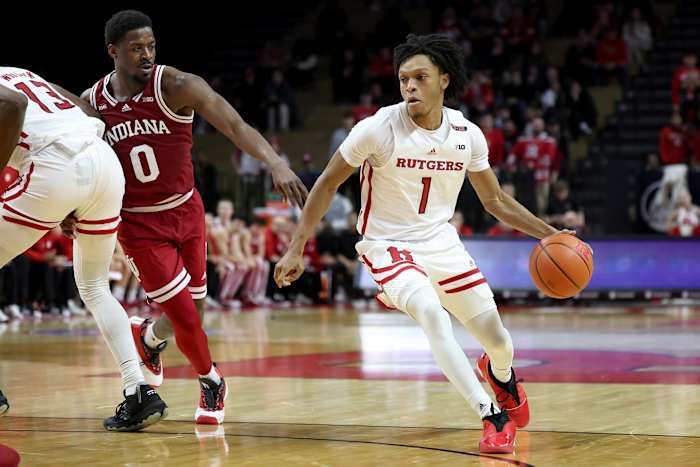 Rutgers Scarlet Knights guard Jamichael Davis (1) dribbles as Indiana Hoosiers guard Xavier Johnson (0) fouls forward Antwone Woolfolk (13) during the second half at Jersey Mike's Arena. Johnson would be ejected after an officials review.